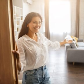 inviting-hindu-lady-gesturing-welcome-into-bright-home-scaled.jpg